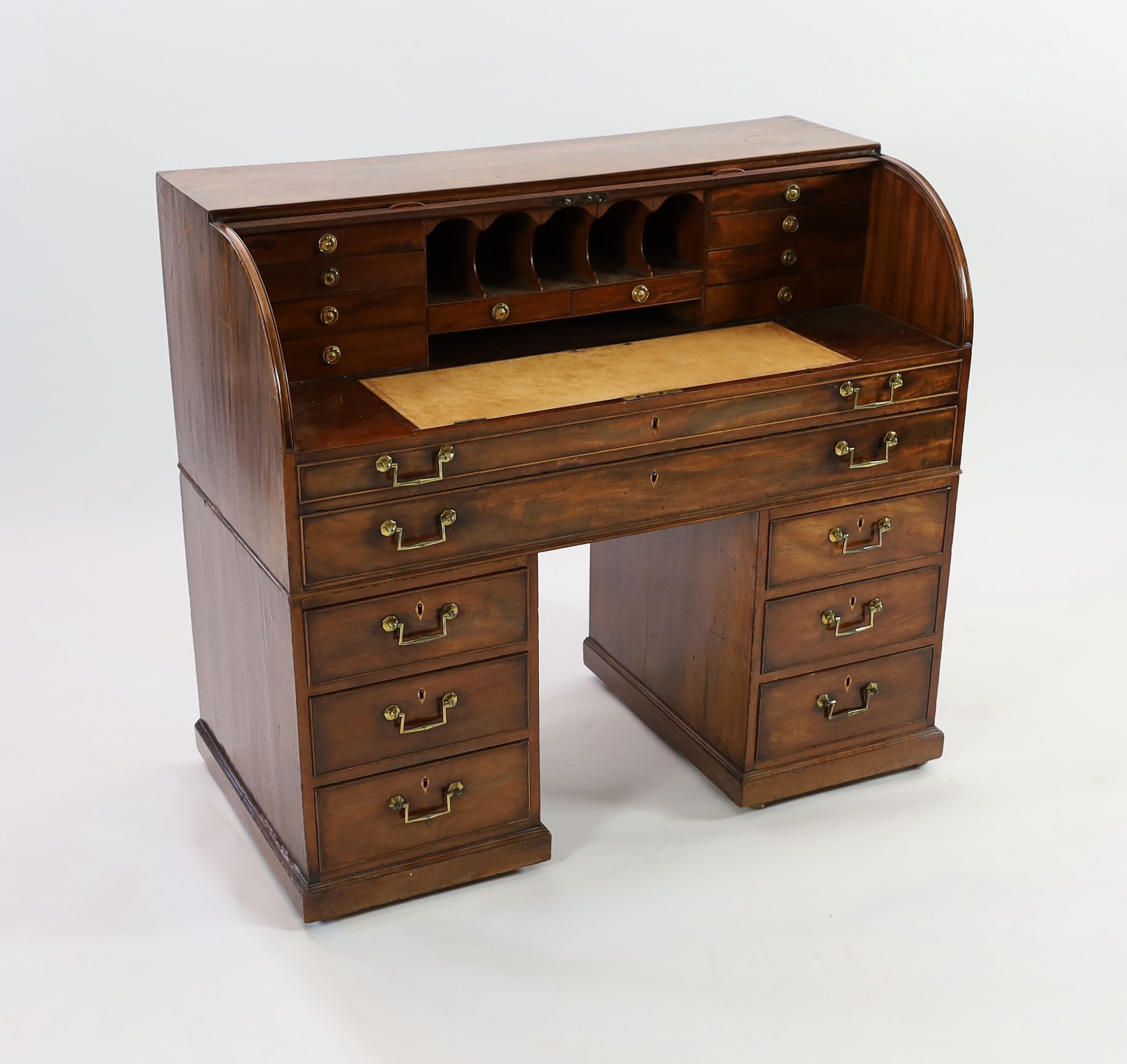 A George III mahogany cylinder top combined writing and dressing kneehole desk, W.122cm D.61cm H.110cm